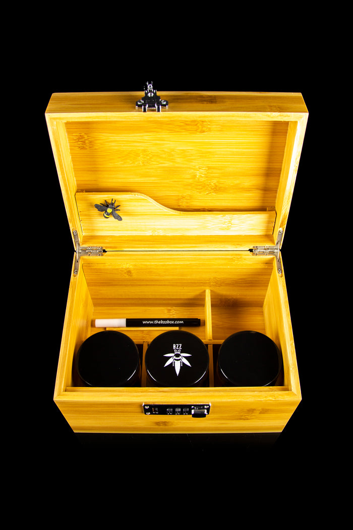 Wooden cannabis storage box with jars and accessories inside.