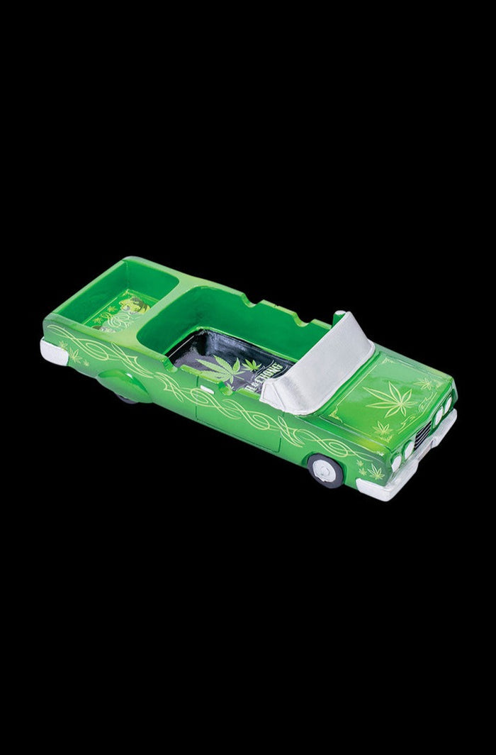 A detailed side view of the Cheech & Chong 50th Anniversary Lowrider Ashtray, showcasing its vintage car-inspired design.