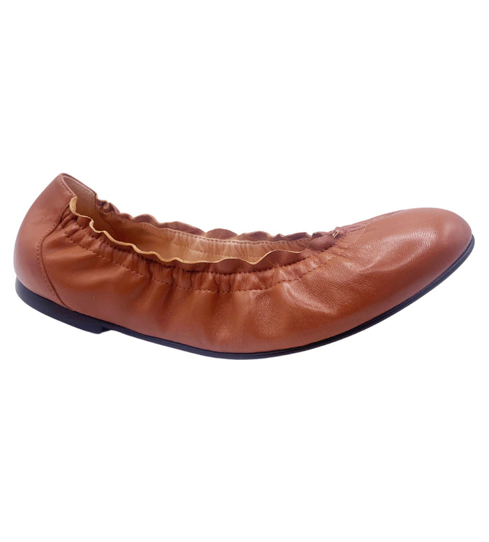 cognac leather ballet flat with a rounded toe and elasticated topline. angle view