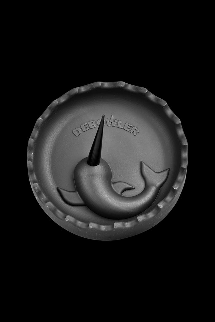 A top-down view of the Debowler Narwhal Silicone Ashtray, featuring a dark grey, whale-shaped design.