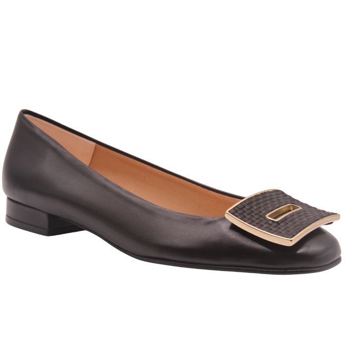 Black leather flat with a square toe, a small heel for slight lift, and a textured black buckle with gold detailing on the toe box angle view