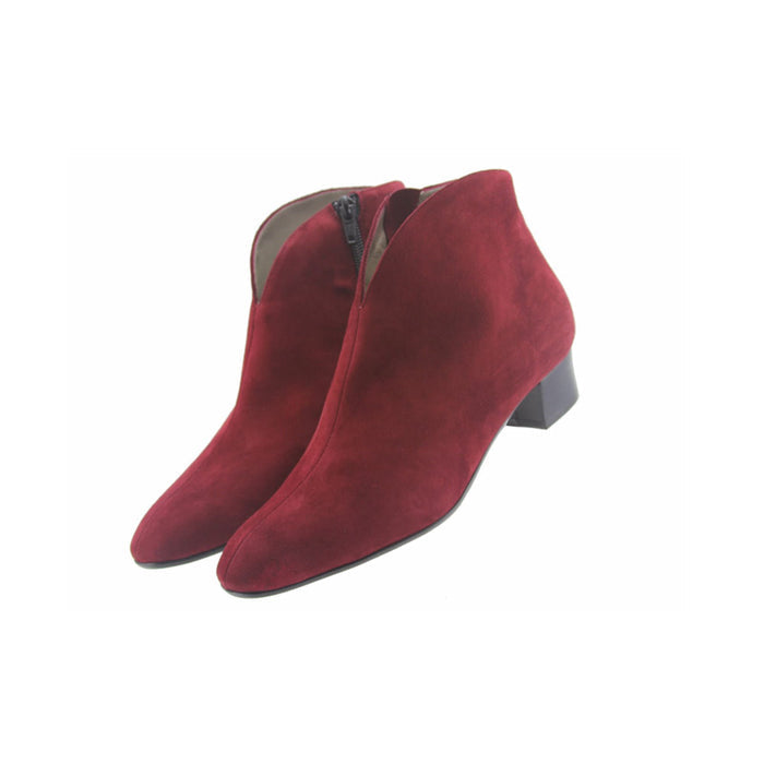 Burgundy suede ankle boot with a low block heel and a smooth, minimal silhouette. both shoes angle view