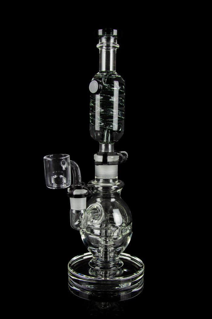 Clear glass water pipe (rig) with a quartz banger, isolated on a black background.