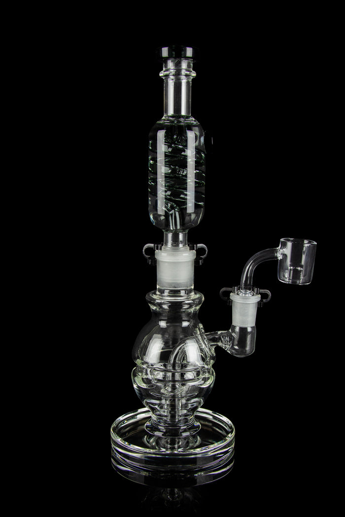 Clear glass water pipe (rig) with bubbler and quartz banger, isolated on a black background.