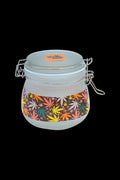 A side view of the Fujima Multicolor Hemp Frosted Glass Jar, featuring a clamp lid and colorful hemp-inspired design.