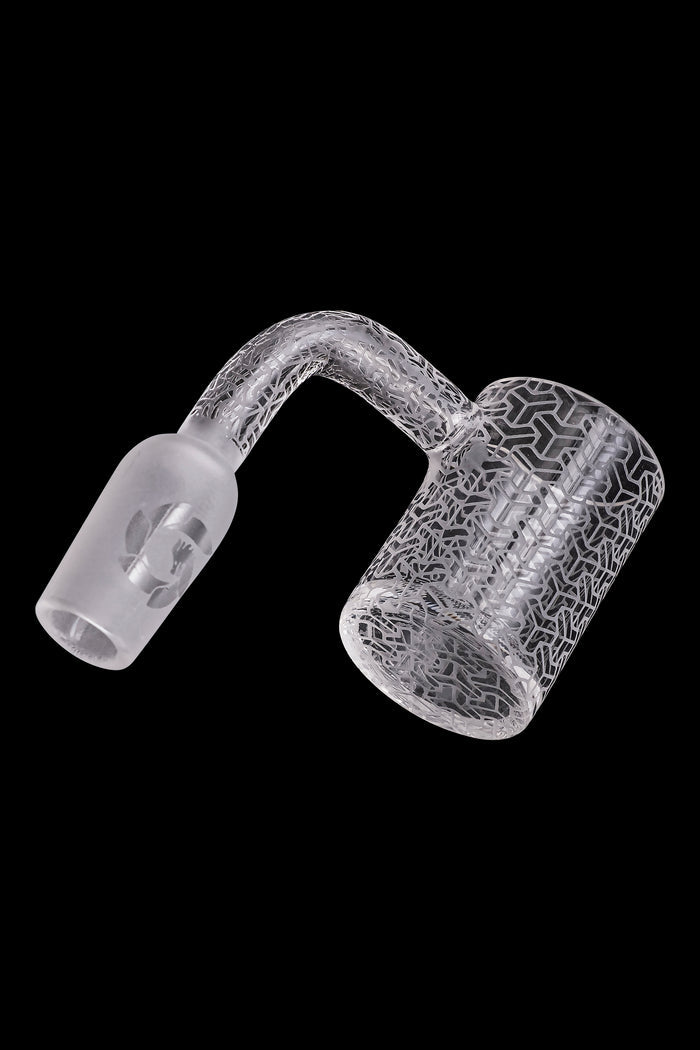 Frosted glass cannabis dab rig with intricate geometric patterns.