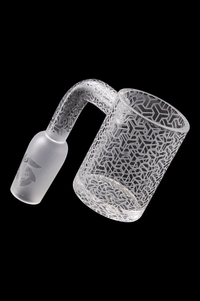 Frosted glass cannabis oil rig attachment with geometric pattern.
