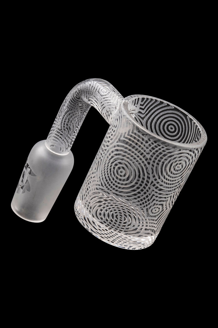 Frosted glass cannabis oil rig with intricate swirling patterns.