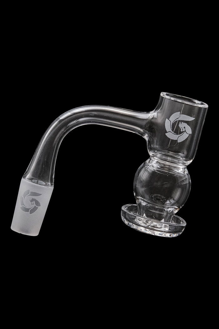Clear glass dab rig with a bubbler design and branded logo, isolated on a black background.