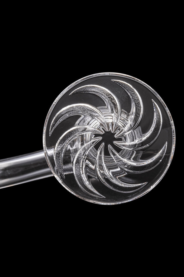 Clear glass cannabis oil rig with a circular, spiral-shaped bowl.