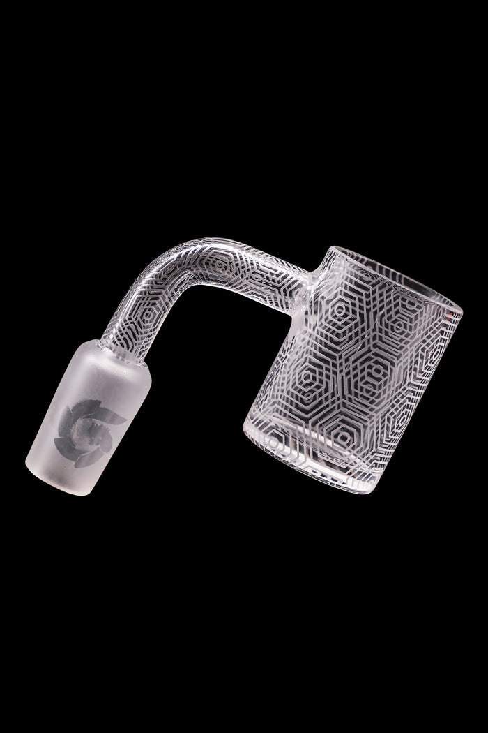 Frosted glass dab rig with geometric pattern and floral accent.