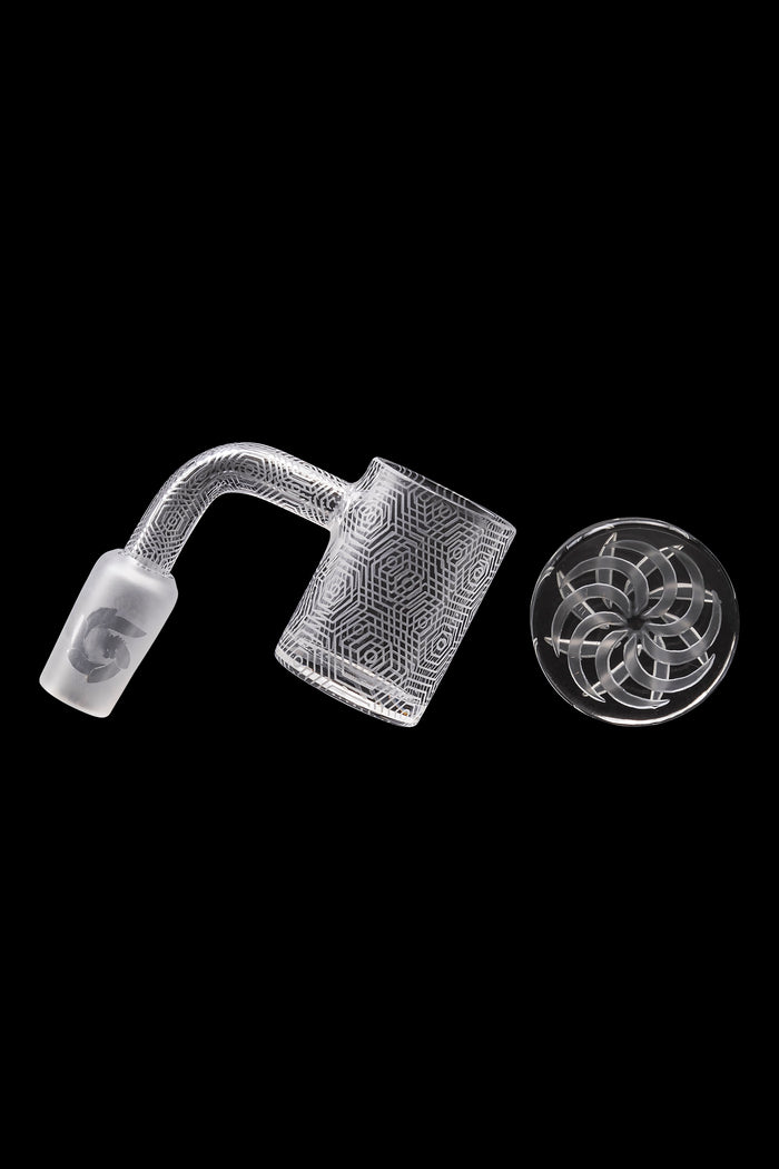 Clear glass dab rig components—a bent neck and insert—with geometric patterns, isolated on a black background.