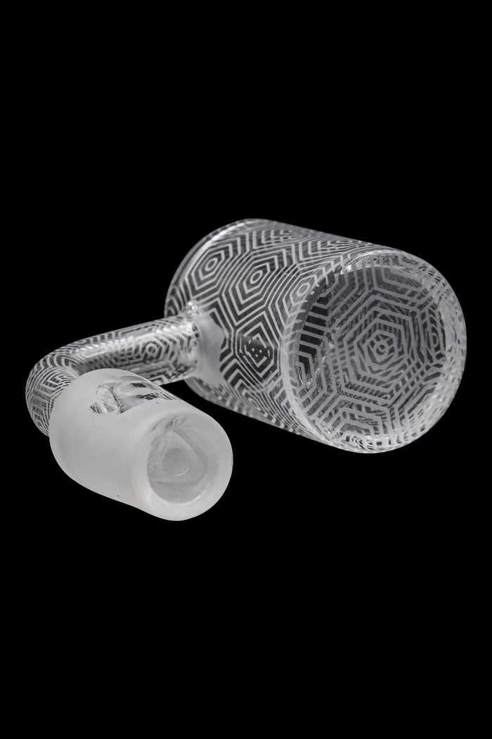 Clear glass bubbler with intricate geometric patterns, isolated on a black background.