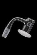 Clear quartz dab rig insert with etched logo, isolated on black.