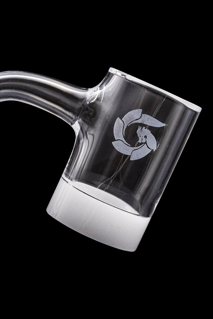 Clear quartz dab rig with white accent and etched logo, isolated on black.