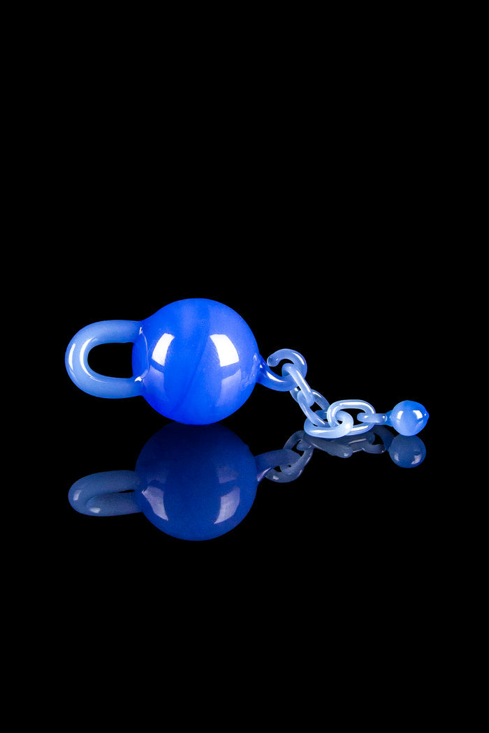 Blue glass water pipe with chain against a black background.