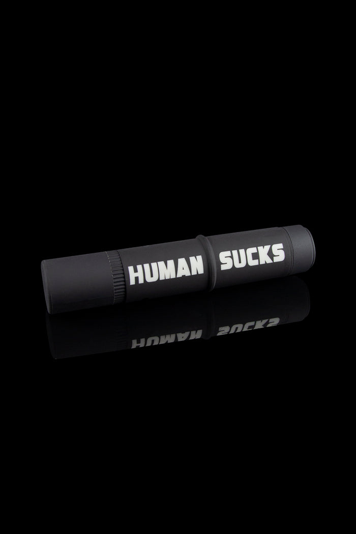 Black cannabis one-hitter pipe and case with white text reading "HUMAN SUCKS".