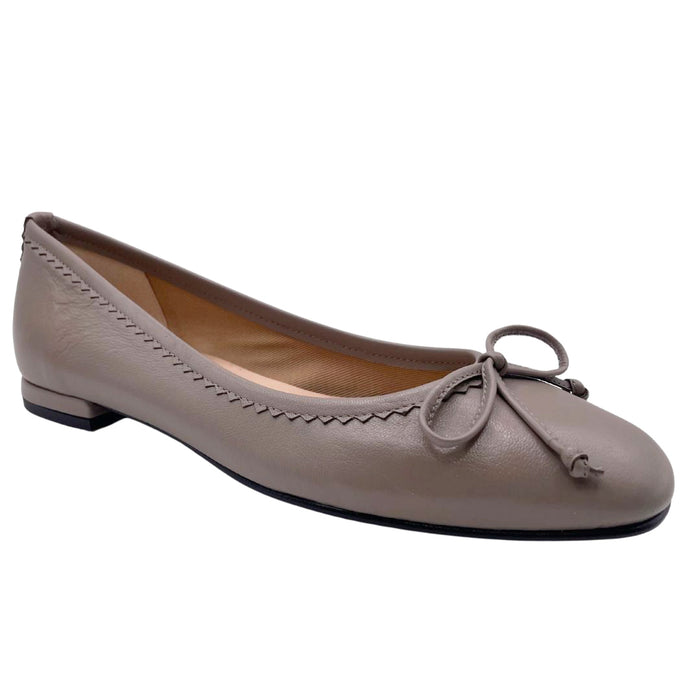 cappuccino leather ballet flat with a rounded toe, leather trim on top line, and a small bow on the front. - angle view