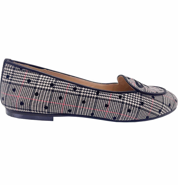 A flat shoe with a black and white plaid pattern and a cushioned leather footbed.