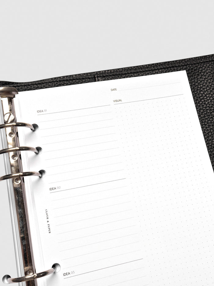 Close up of Mental Download inserts inside discbound planner and leather cover.