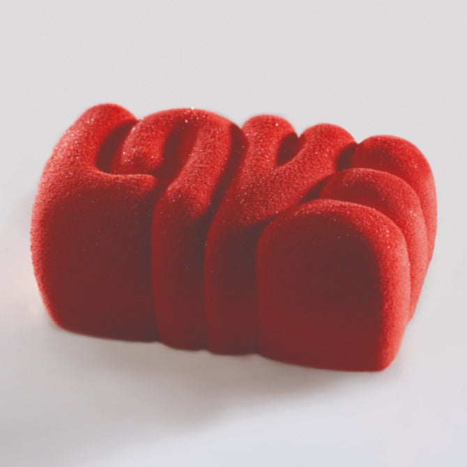 A silicone mold with a smooth surface, rectangular in shape, spelling "Love" designed for baking or freezing food items.