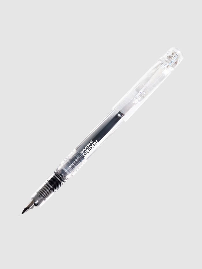 Platinum Preppy Fountain Pen, Crystal, Cloth and Paper. Pen uncapped with cap posted, turned to the right against a neutral background.