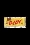 The RAW Classic Pack Glass Ashtray is shown in a close-up, angled view with visible branding on a black background.