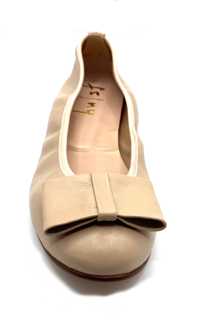 Beige leather ballet flat with a rounded toe and a large folded bow accent on the front. front  view