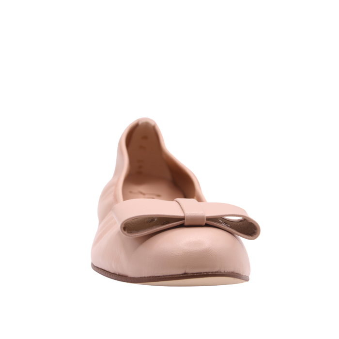 Blush leather ballet flat with a rounded toe and a large folded bow accent on the front. front view