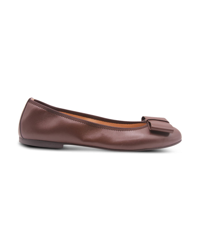 chocolate brown leather ballet flat with a rounded toe and a large folded bow accent on the front. Side view