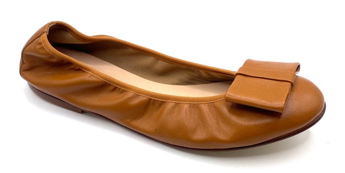 Brown leather ballet flat with a rounded toe and a large folded bow accent on the front. Angle View