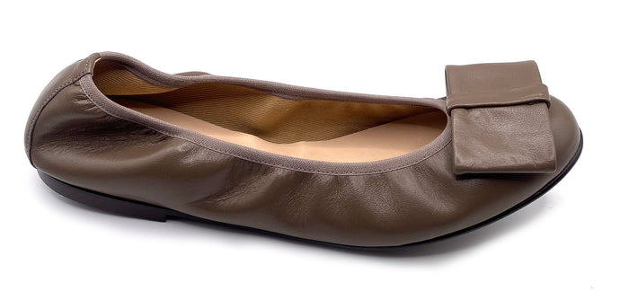 Taupe Leather ballet flat with a rounded toe and a large folded bow accent on the front. Side View
