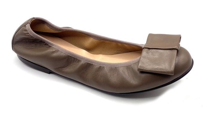 Taupe leather ballet flat with a rounded toe and a large folded bow accent on the front. Angle view
