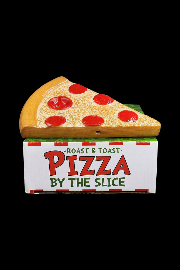 A wooden pizza slice rests on a red and green box labeled “Pizza by the Slice” – likely a discreet container for cannabis accessories.