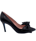 A black leather heel with a pointed toe and an oversized bow on the top.